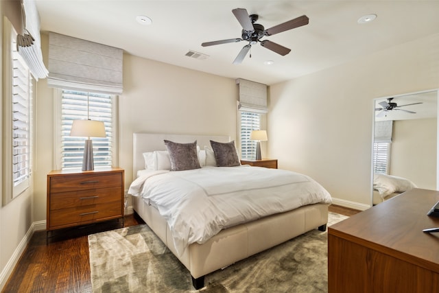 bedroom with ceiling fan and dark hardwood / wood-style floors