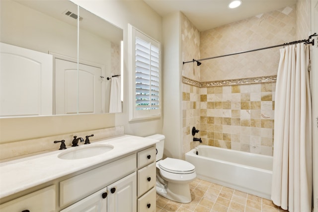 full bathroom featuring vanity, shower / tub combo, and toilet