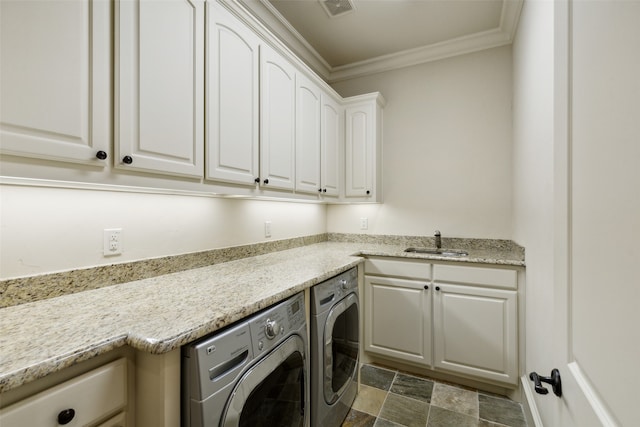 washroom with ornamental molding, separate washer and dryer, sink, and cabinets