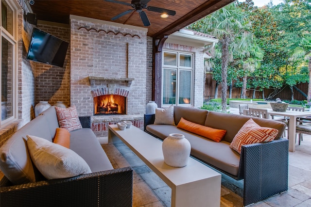 view of patio featuring an outdoor living space with a fireplace and ceiling fan