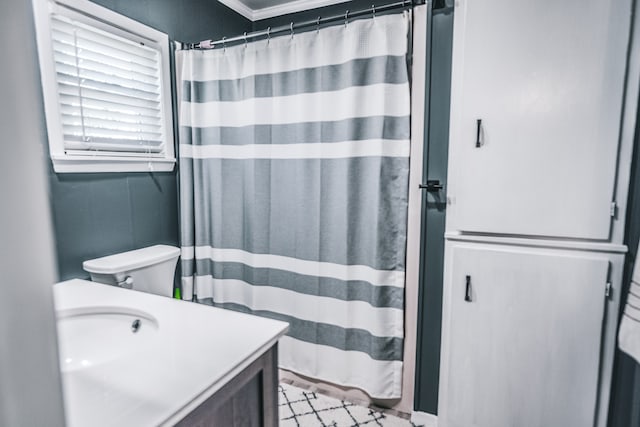 bathroom with walk in shower, crown molding, vanity, and toilet