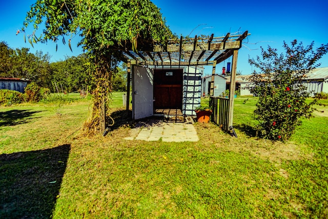 view of outdoor structure featuring a lawn and a pergola