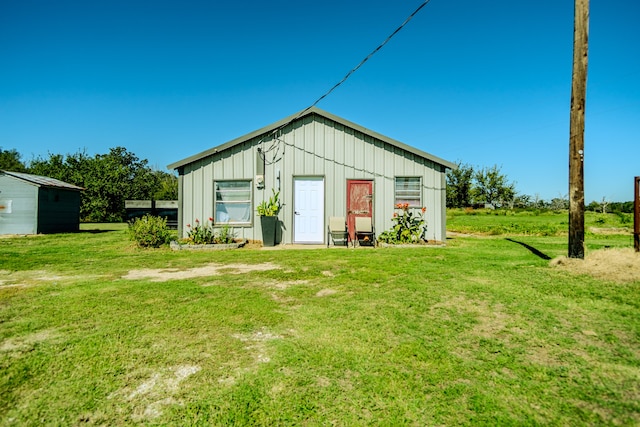 view of outbuilding featuring a yard