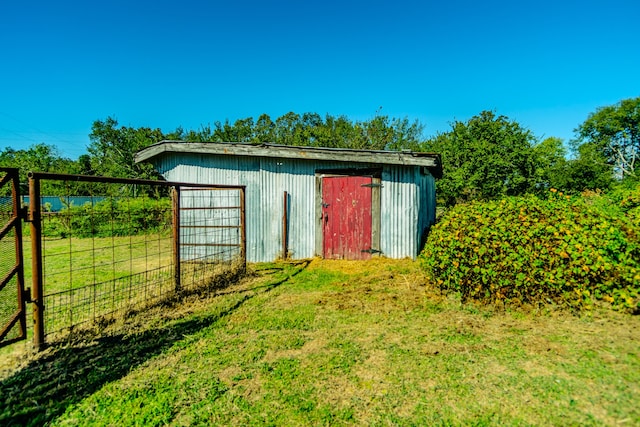 view of outbuilding featuring a yard