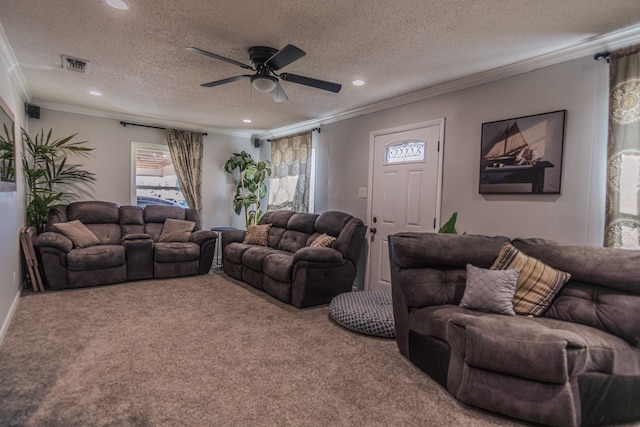 carpeted living room featuring a textured ceiling, ceiling fan, and crown molding