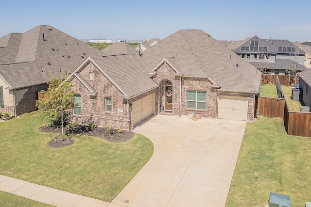 view of front of property featuring a garage and a front yard