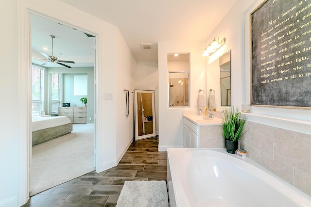 bathroom featuring vanity, a bath, and ceiling fan