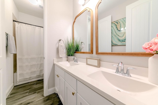 bathroom with shower / bath combo and vanity