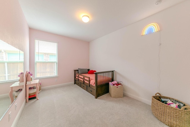 carpeted bedroom with a nursery area and multiple windows