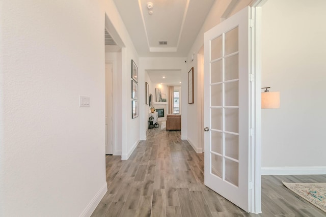 corridor with light hardwood / wood-style flooring