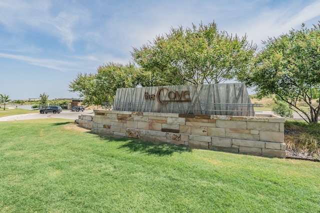 community sign featuring a yard