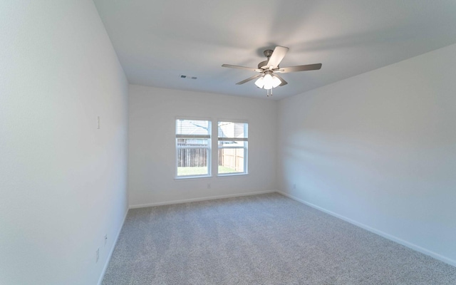 empty room featuring ceiling fan and carpet