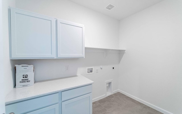 laundry area with washer hookup, electric dryer hookup, cabinets, and gas dryer hookup