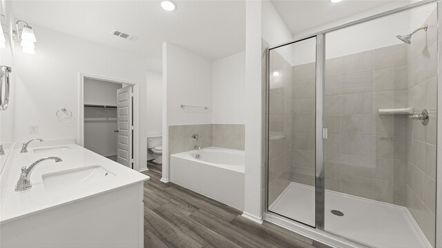 bathroom with vanity, wood-type flooring, and shower with separate bathtub