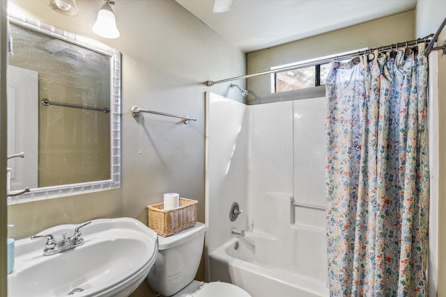 full bathroom with shower / bath combination with curtain, sink, and toilet