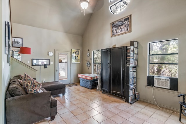 entrance foyer featuring light tile patterned floors, ceiling fan, cooling unit, and high vaulted ceiling