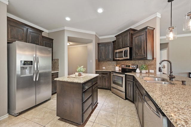 kitchen with dark brown cabinetry, sink, pendant lighting, and stainless steel appliances