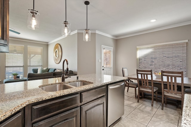 kitchen featuring dark brown cabinets, light stone counters, sink, decorative light fixtures, and ornamental molding