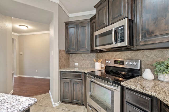 kitchen with light hardwood / wood-style floors, stainless steel appliances, dark brown cabinetry, crown molding, and light stone countertops