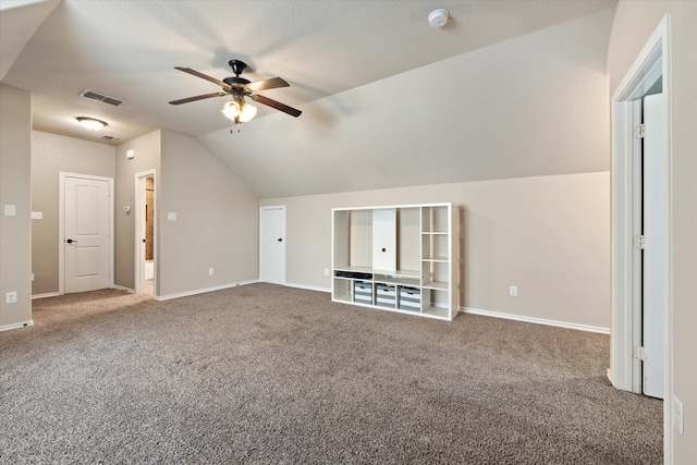 unfurnished living room with carpet, vaulted ceiling, and ceiling fan