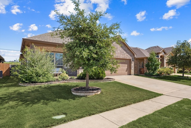 view of front of home with a garage and a front lawn