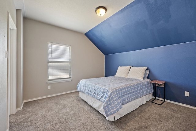 bedroom featuring lofted ceiling and carpet