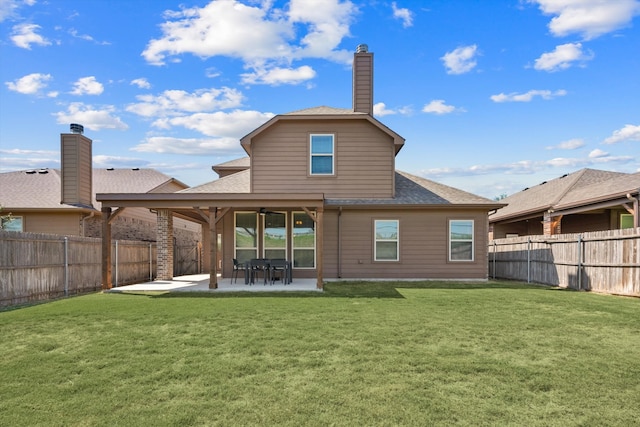 back of house with a yard and a patio area