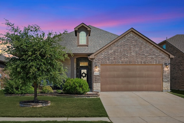 view of front facade featuring a lawn and a garage