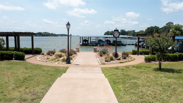 view of dock featuring a yard and a water view