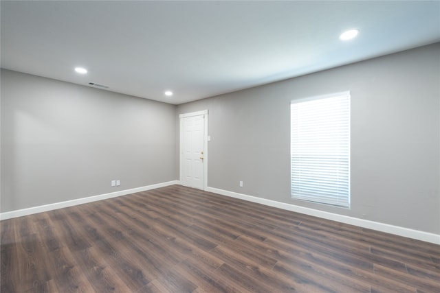 spare room with dark hardwood / wood-style floors