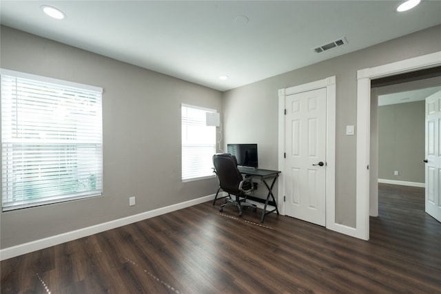 office space with dark hardwood / wood-style floors and a healthy amount of sunlight