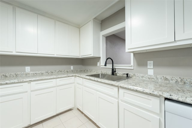 kitchen featuring dishwasher, white cabinetry, light tile patterned flooring, and sink