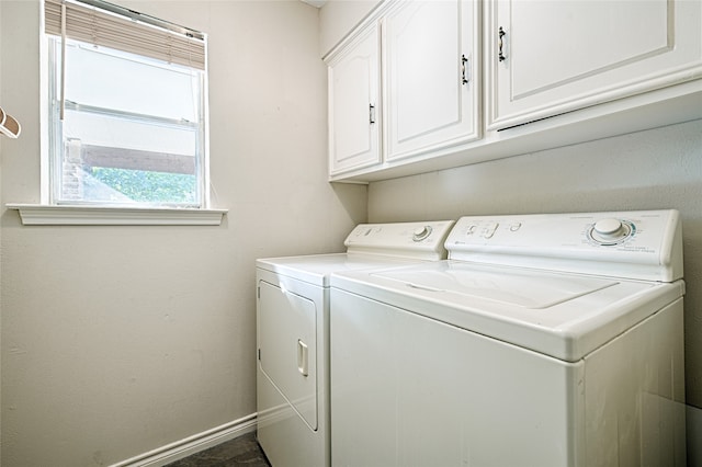 washroom with cabinets and washing machine and clothes dryer