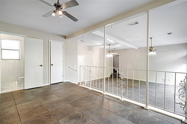 unfurnished room featuring beamed ceiling