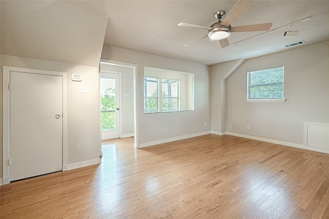 interior space featuring light hardwood / wood-style flooring, a textured ceiling, and ceiling fan