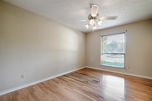 spare room featuring light hardwood / wood-style floors, a textured ceiling, and ceiling fan