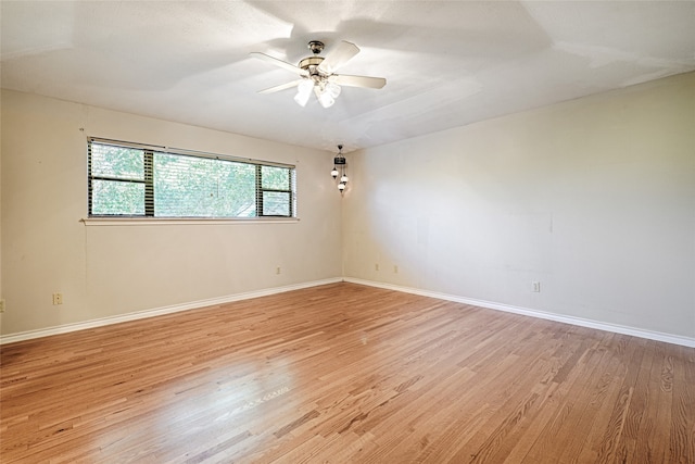 spare room with light wood-type flooring and ceiling fan