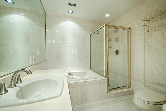 full bathroom featuring independent shower and bath, sink, toilet, and tile walls