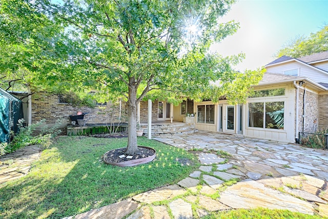 back of property with a patio and a lawn