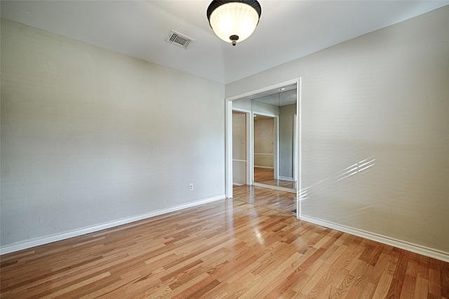 spare room with light hardwood / wood-style floors