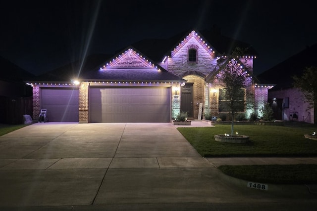 view of front of home with a lawn and a garage