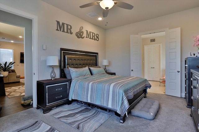 bedroom with ceiling fan and hardwood / wood-style flooring