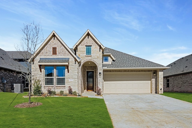 view of front facade featuring cooling unit, a garage, and a front yard