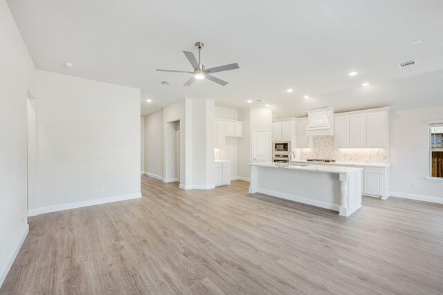 living room with light wood-type flooring and ceiling fan