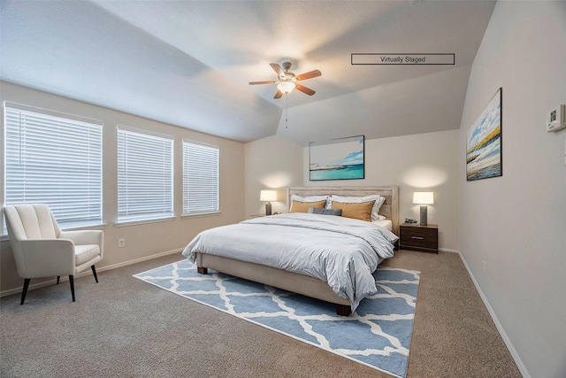 carpeted bedroom with lofted ceiling, a ceiling fan, and baseboards