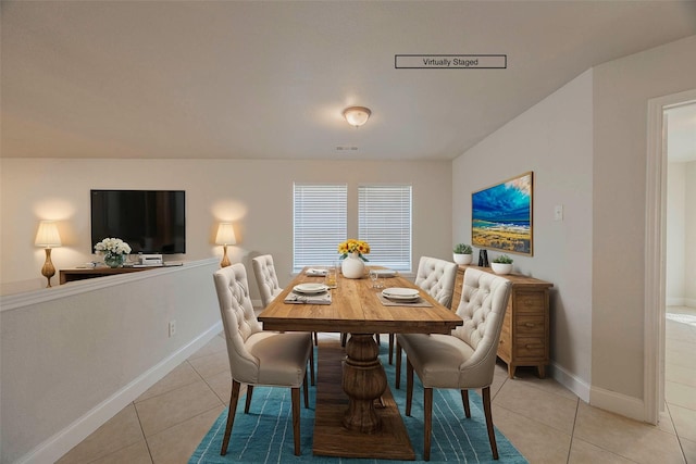 dining room featuring baseboards and light tile patterned floors