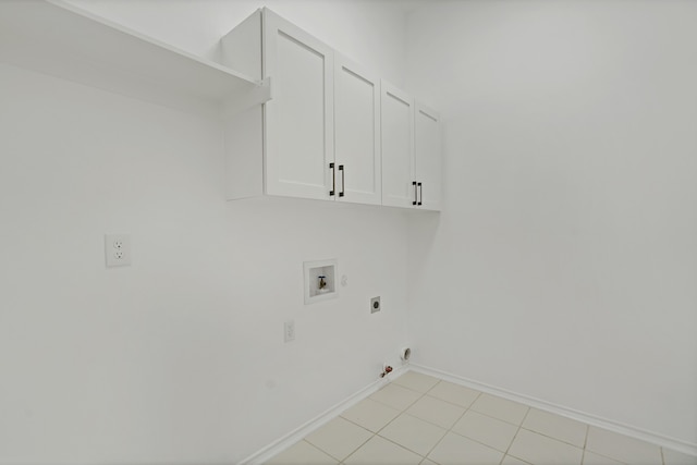 clothes washing area with light tile patterned flooring, gas dryer hookup, cabinets, hookup for a washing machine, and electric dryer hookup