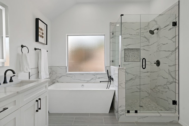 bathroom with vanity, lofted ceiling, and shower with separate bathtub