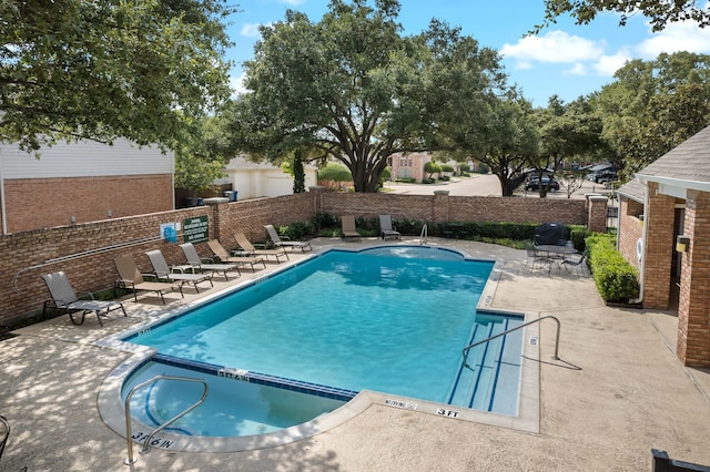 view of swimming pool with a patio area