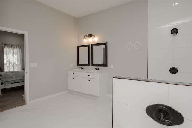 bathroom featuring a shower and vanity